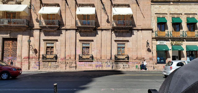 proest graffiti scrawled across a historic building