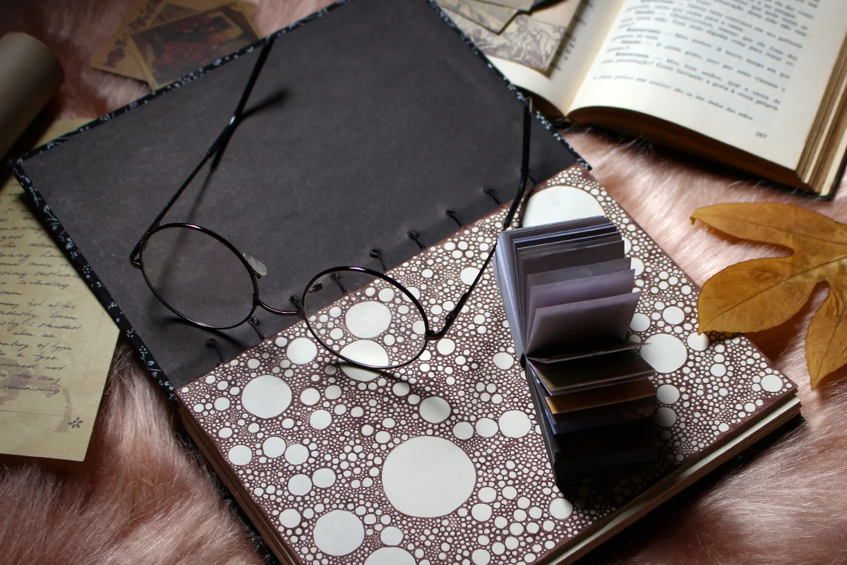 a pair of vintage glasses on top of a journal