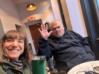 A selfie of me and my friend Richard in Starbucks. Richard is waving.