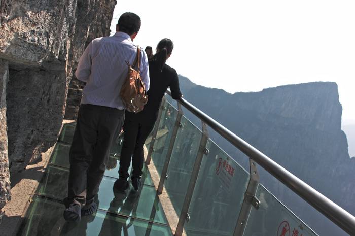 Jutting out from a sheer cliff 1,430 meters high, the glass skywalk in Zhangjiajie National Forest Park offers sightseers terrifying thrills and clear view of the mountains below as they tread nervously across the 60 meter long bridge encircling the vertical cliffs of Tianmen Mountain in Hunan province. The 3ft-wide, 2.5in thick glass walkway is so scary that sightseers are requested to wear cloth slip-ons over their shoes when they cross the skywalk, presumably to make the job easier for the cleaners.