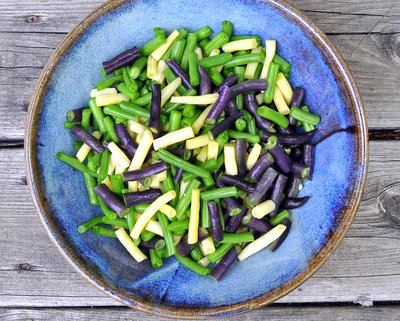 Cut-up green beans, purple beans and yellow beans in a blue bowl ♥ AVeggieVenture.com.