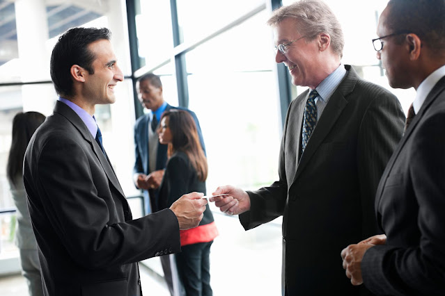 Aviation customers meeting and exchanging business cards to show customer relationship that should be tracked in CRM software.