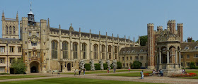 A courtyard with old buildings around it including a clock tower