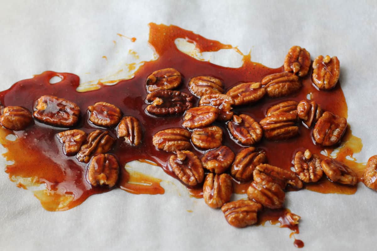 Pecan brittle on a piece of parchment.