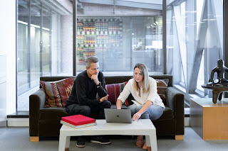 Two people meeting in an office | Collection agency Muskegon