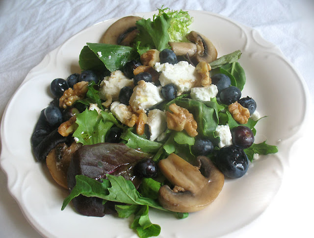 blueberry caprine animal cheese salad alongside mushrooms