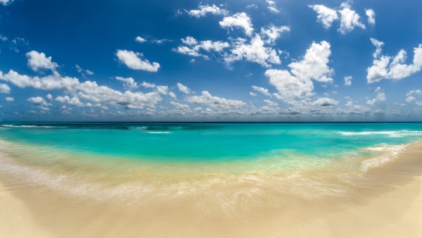 beautiful sand beach of Cancun with turquoise waves and blue skies