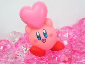 A Nintendo Kirby figure holding a pink heart