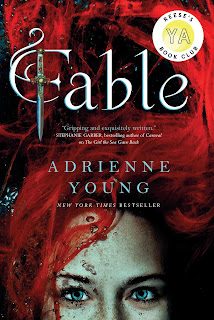 top half of the face of a girl with crimson red hair. Fable written in curly script lettering