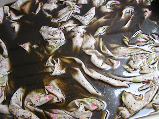 Close up of fabric soaking in leftover coffee grounds and water.