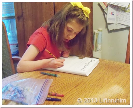 Supergirl does copywork from Chem Physic Junior Notebook