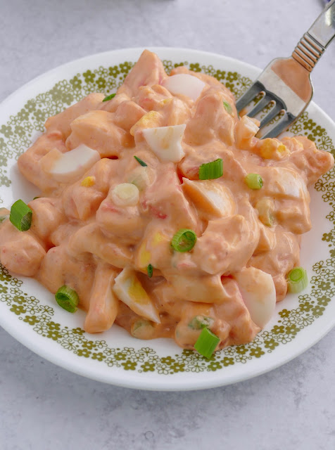 French Dressing Potato Salad on a white and green plate.