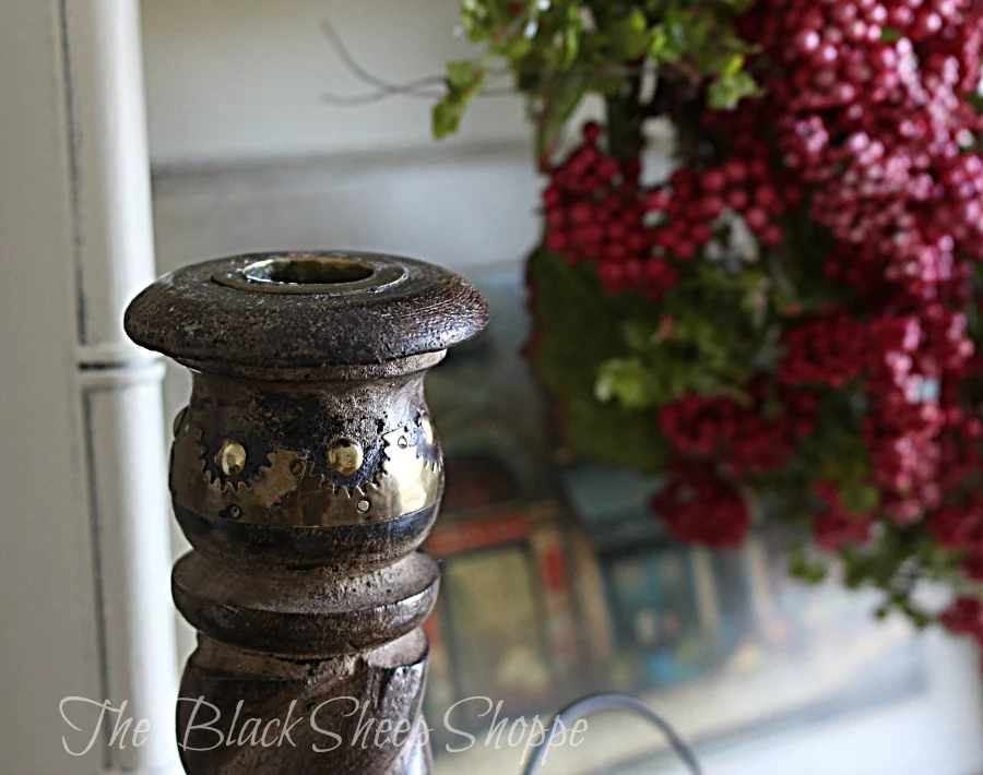 Wood candlestick with metal details.