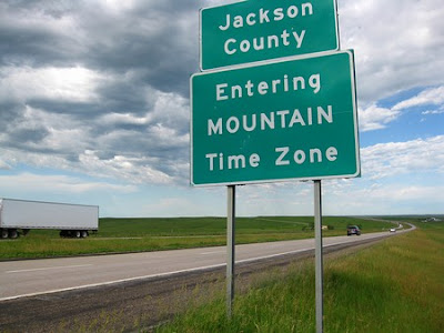 Mountain time zone road sign