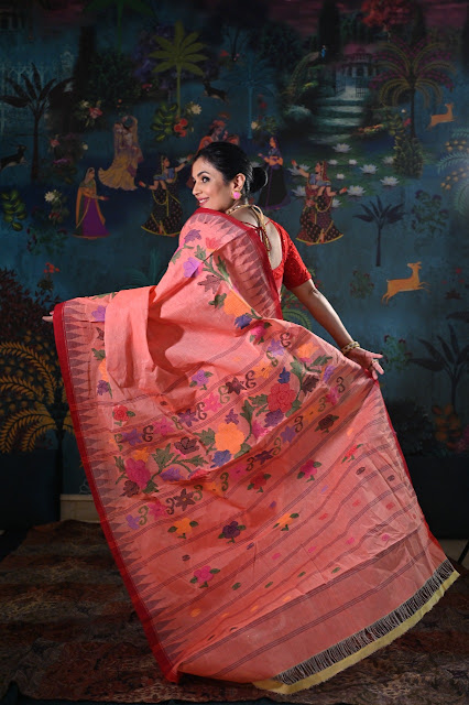 Peachish pink cotton moirang phee from with jamdani rose motifs on pallu.