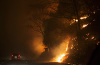 Fire erupts on the side of The Spur on Highway 441 between Gatlinburg and Pigeon Forge, TN, on Monday night, November 28, 2016. In Gatlinburg, smoke and fire caused the mandatory evacuation of downtown and surrounding areas. (Image credit: Jessica Tezak/Knoxville News Sentinel via AP) Click to Enlarge.