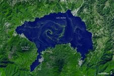 A large bloom of cyanobacteria spread across Guatemala’s Lake Atitlán in green filaments, visible in this simulated-natural-color image from ASTER data taken Nov. 22, 2009