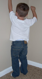 My son climbing the wall in his Denizen blue jeans