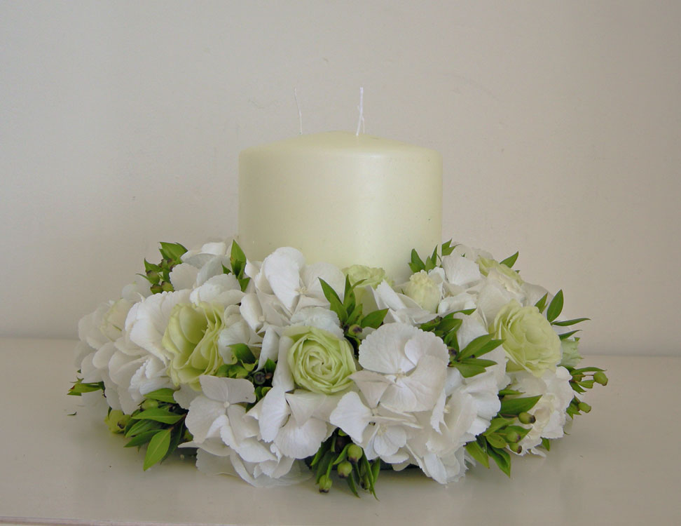This design uses a chunky candle with white hydrangea green lisianthus and