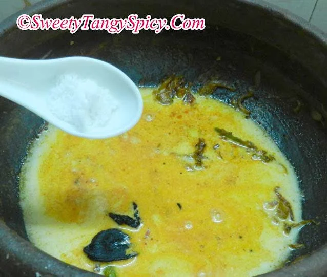 Adding remaining thin coconut milk, pot tamarind (kudampuli) soaked in water, and salt to the simmering curry