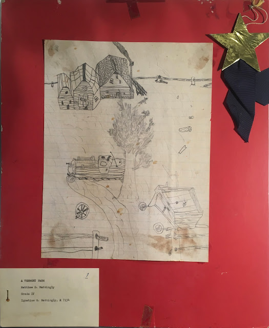 Child's drawing of farmhouse, barn, pickup truck, tree, wagon and fence, mounted on red posterboard. Gold star and blue ribbon affixed upper right. Label lower left reads : "A Vermont Farm Matthew D. Mattingly Grade IV Ignatius G. Mattingly X7134