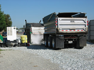 On leaving the work area, the truck receives a spray cleaning to prevent the trackout of dust or mud onto neighborhood streets.