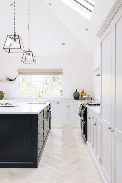 Minimal modern farmhouse kitchen with Shaker cabinets, high ceilings and modern lighting - found on Hello Lovely Studio