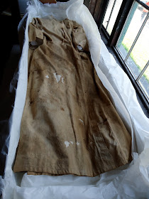 Edison's lab coat before treatment by Art Conservator and historic textile expert, Gwen Spicer