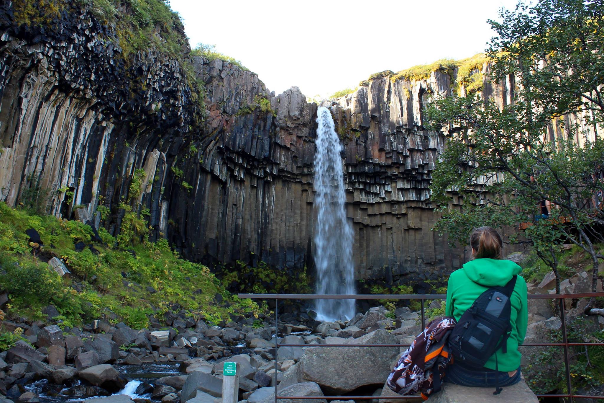 Kathi sitting in front of Svartifoss waterfall
