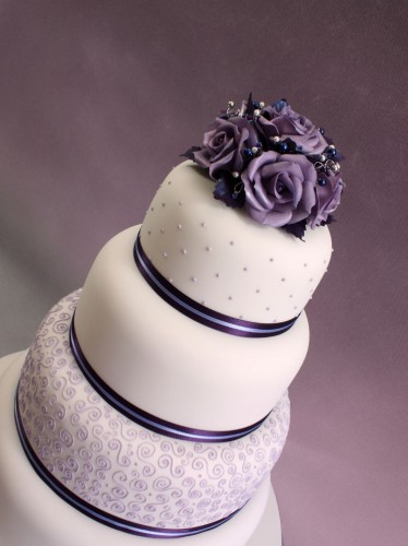 4 Tier Round with Purple Roses 4 tier round cake with ribbons around every