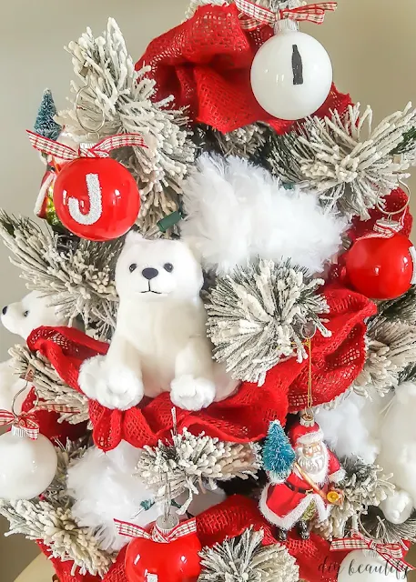 Transform a tabletop Christmas tree with a Coca Cola theme. You can find out how I decorated this adorable tree at diy beautify!