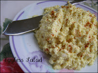 Eggless salad on pastel girly dish with fancy spreader upon rose table linen