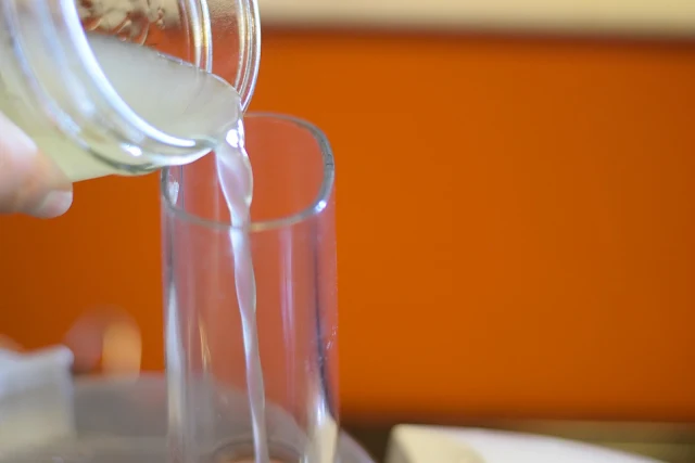 The chick pea liquid being added to the food processor.  