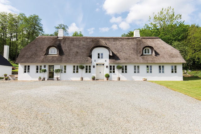 Historical European farmhouse with thatched roof in Danish countryside on Hello Lovely Studio