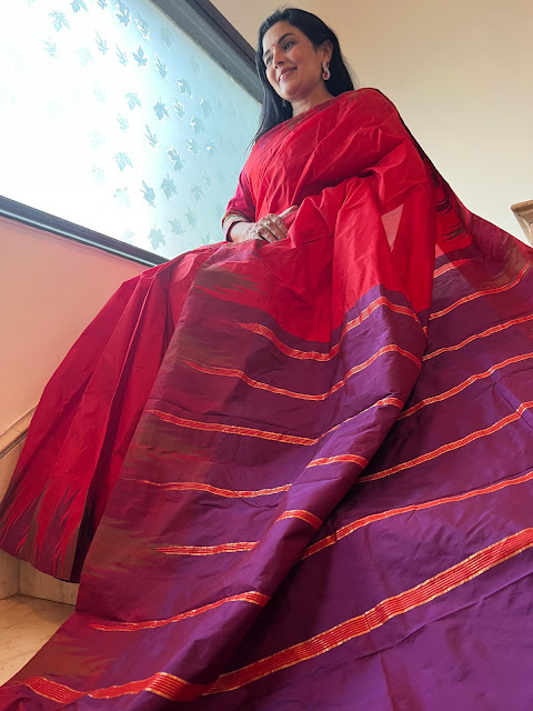 Red silk Knajeewaram saree with an aubergine temple border and pallu