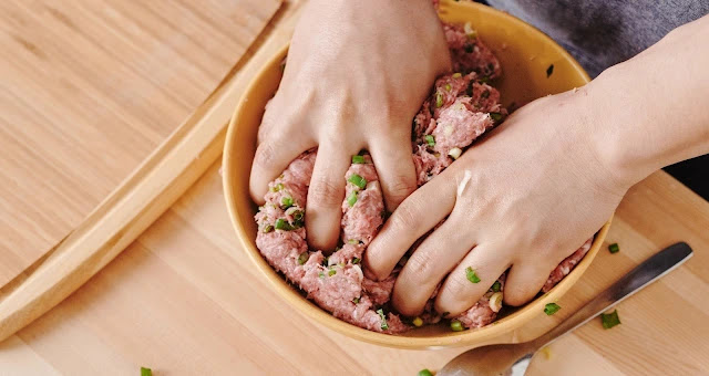 mixing crab meat chopped garlic in bowl