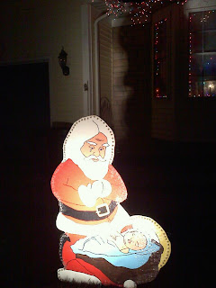 Santa Bowing Down to Baby Jesus yard art