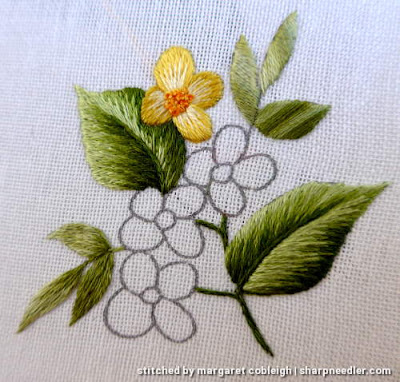 Motif with yellow flowers showing different ways to use variegated House of Embroidery threads on the leaves.