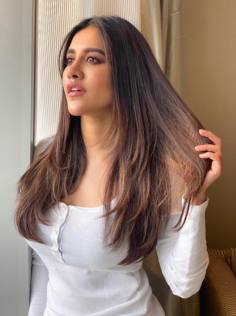 Nabha Natesh looks adorable in a cute pose, dressed in a white outfit