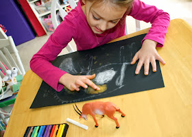 After the glue dried and left an embossing of Tessa's antelope sketch, she "colored" in her design by rubbing and blending chalk with her fingers. She really enjoyed this part of the project.