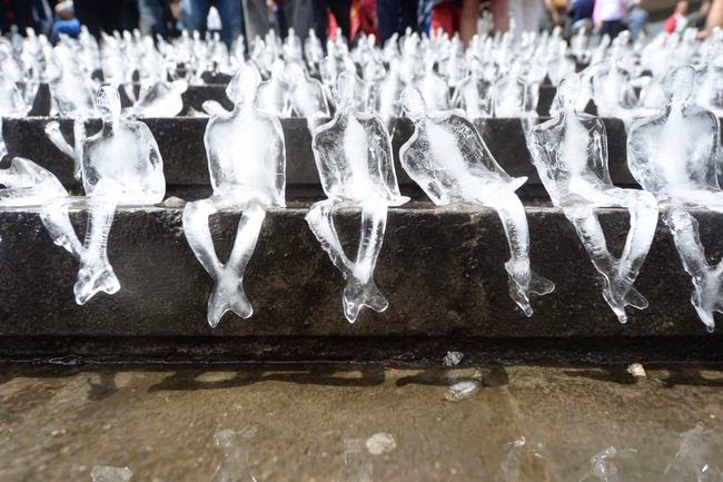 People took their turns placing the ice sculptures on the stairs. - To Commemorate WWI, This City Created A Powerful Temporary Ice Monument.