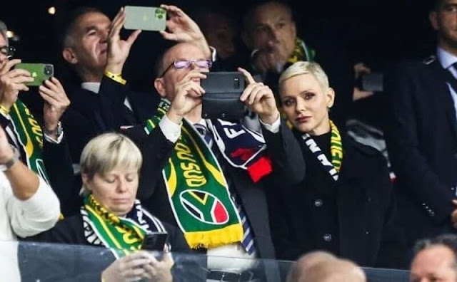 Princess Charlene wore a navy wool coat by Akris. Black leather trousers. France had not beaten South Africa since 2009