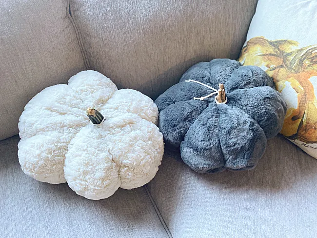 white and grey pumpkin shaped pillows