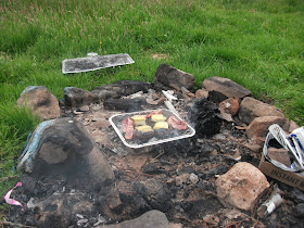 Grub cooking on a well used fire pit
