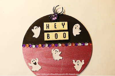 Round wooden sign with ribbon ghosts, gems and wooden tile letters