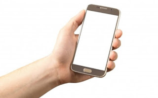 A picture of a mobile phone being held in someone's hand