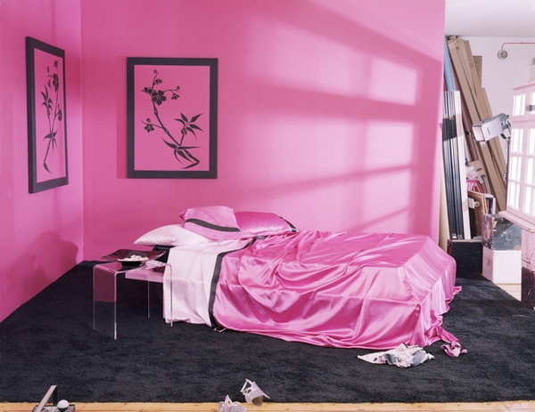 sultry girly and fun bedroom in pink and black with pink satin sheets