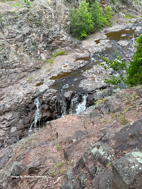 A waterfall daintily trickles over the craggy, worn rocks of Lester Park in Duluth, Minnesota.