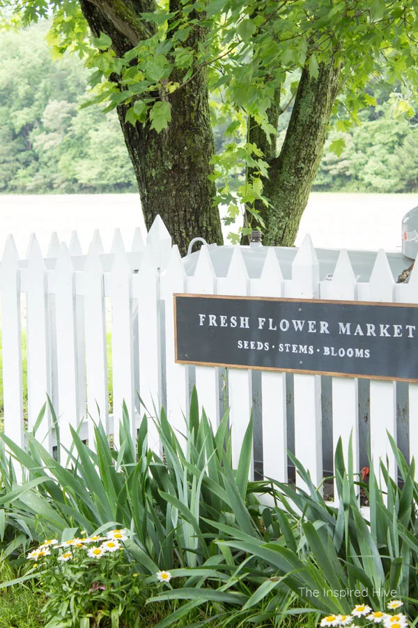 Great idea to hide a propane gas tank in the yard with a cute picket fence! Plus how to maintain the fence to keep it nice and bright.