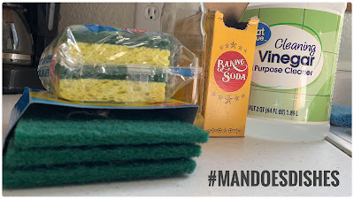 Green Scrubbers, Sponges, Baking Soda, VInegar and Dish Soap o the kitchen counter.
